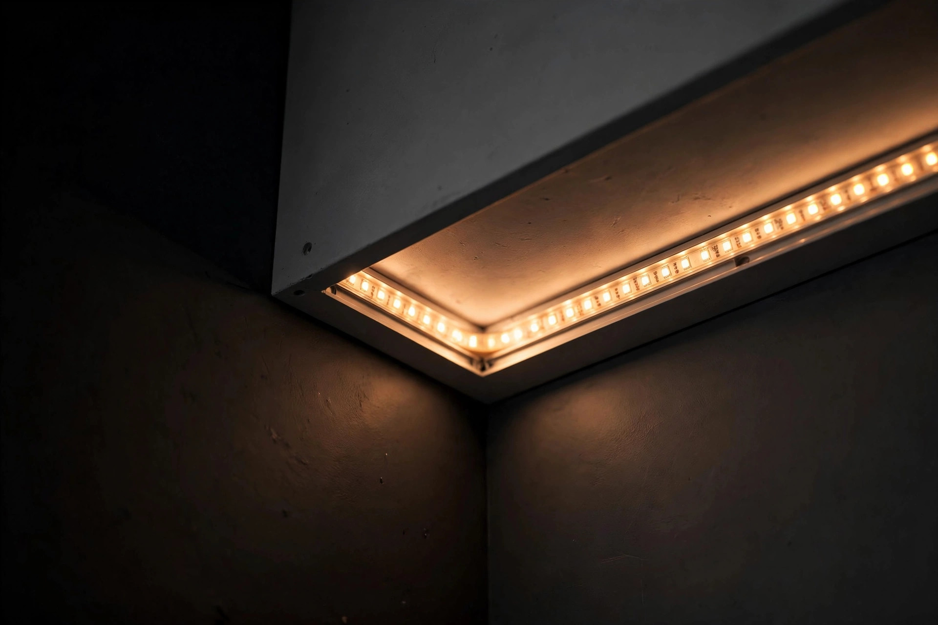 Close-up concept render of warm LED cove lighting along a false ceiling edge