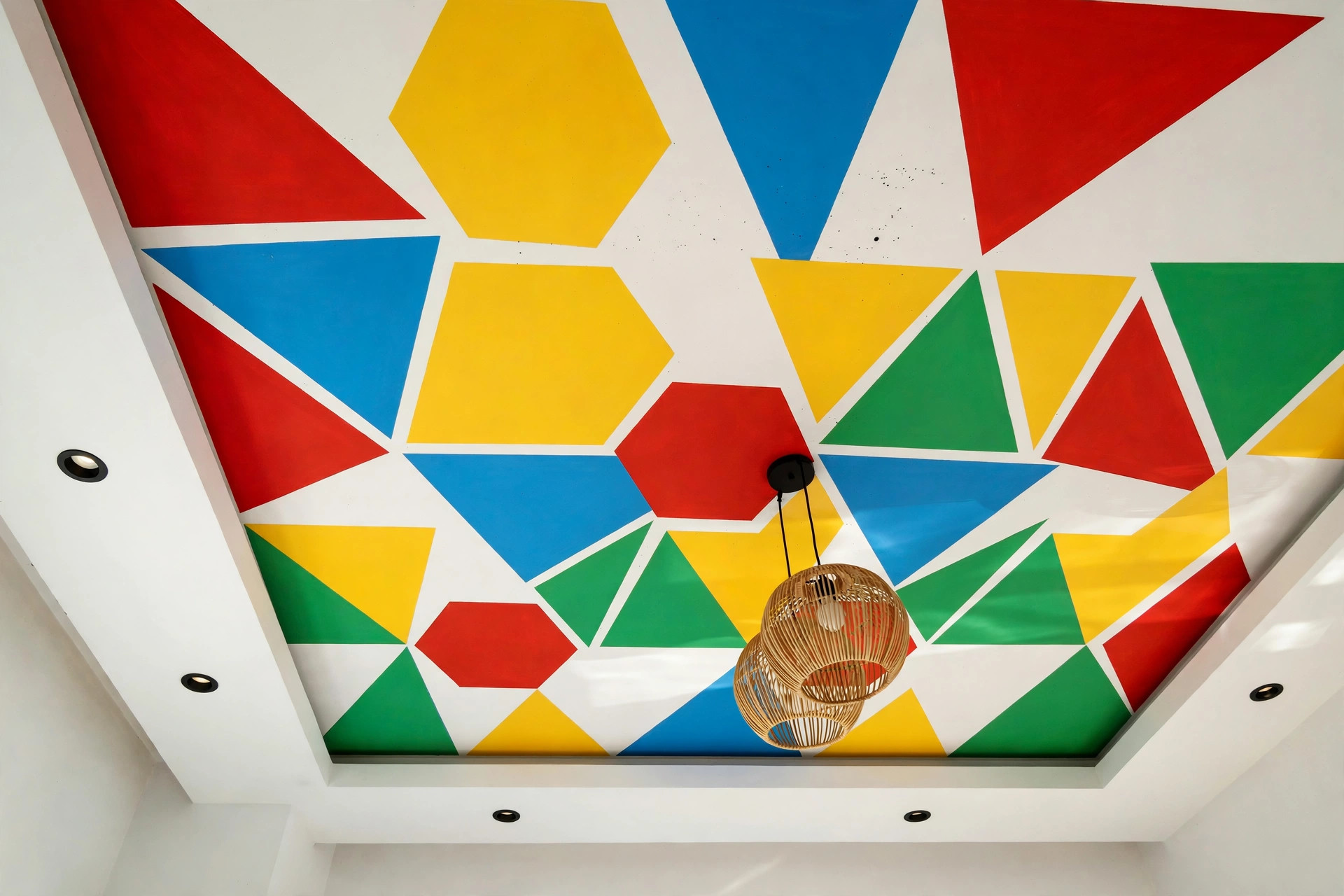 Concept render of a kids bedroom ceiling with bold geometric color blocks in red yellow blue and green