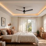 Bedroom with a gypsum tray false ceiling and a ceiling fan at the centre, warm cove light along the tray edge
