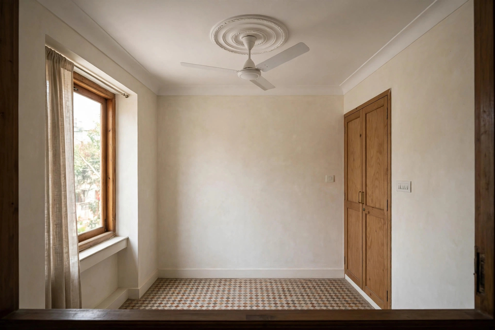 Decorative circular medallion ring around a ceiling fan on a white ceiling
