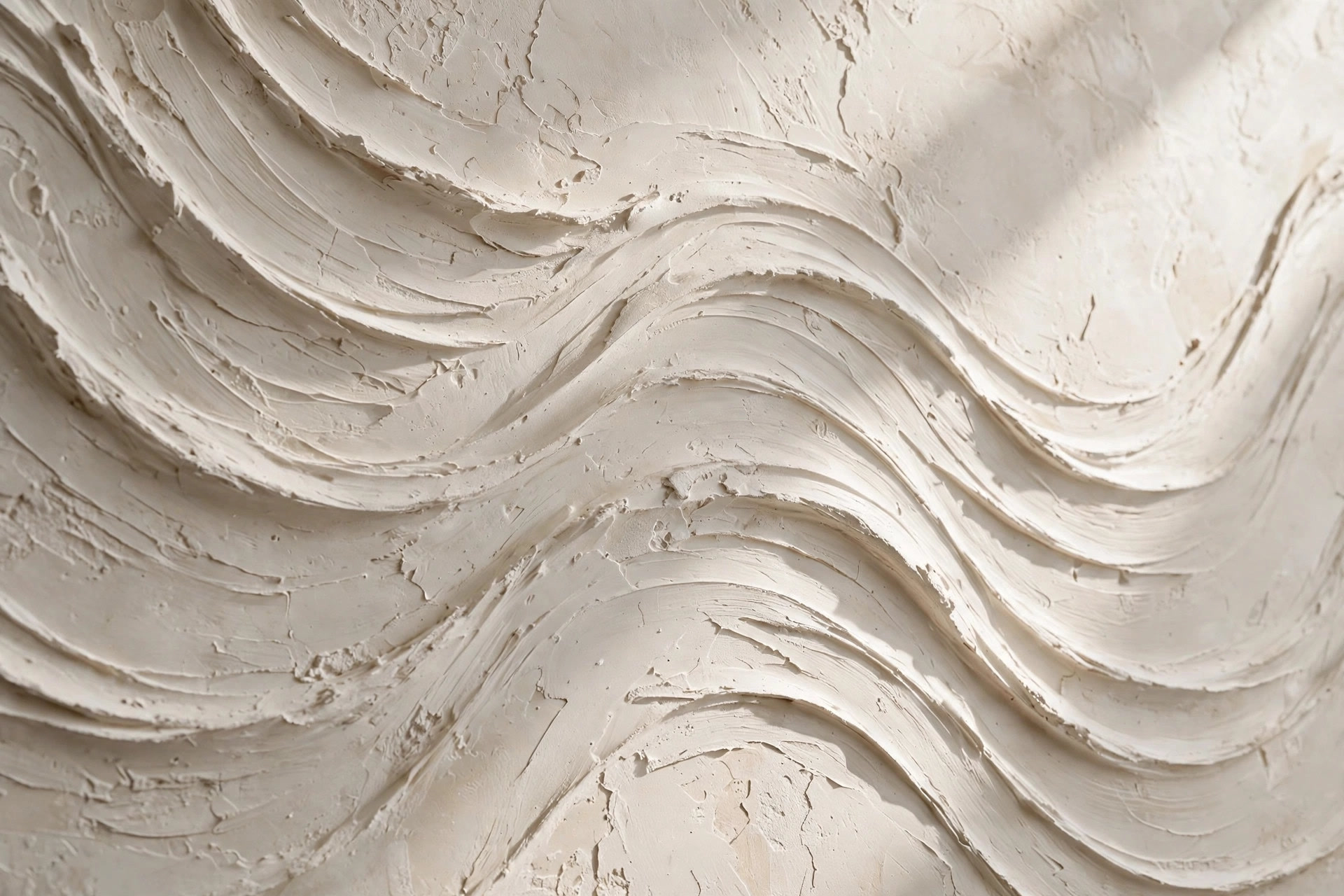 Close-up of hand-textured POP plaster with a wave pattern
