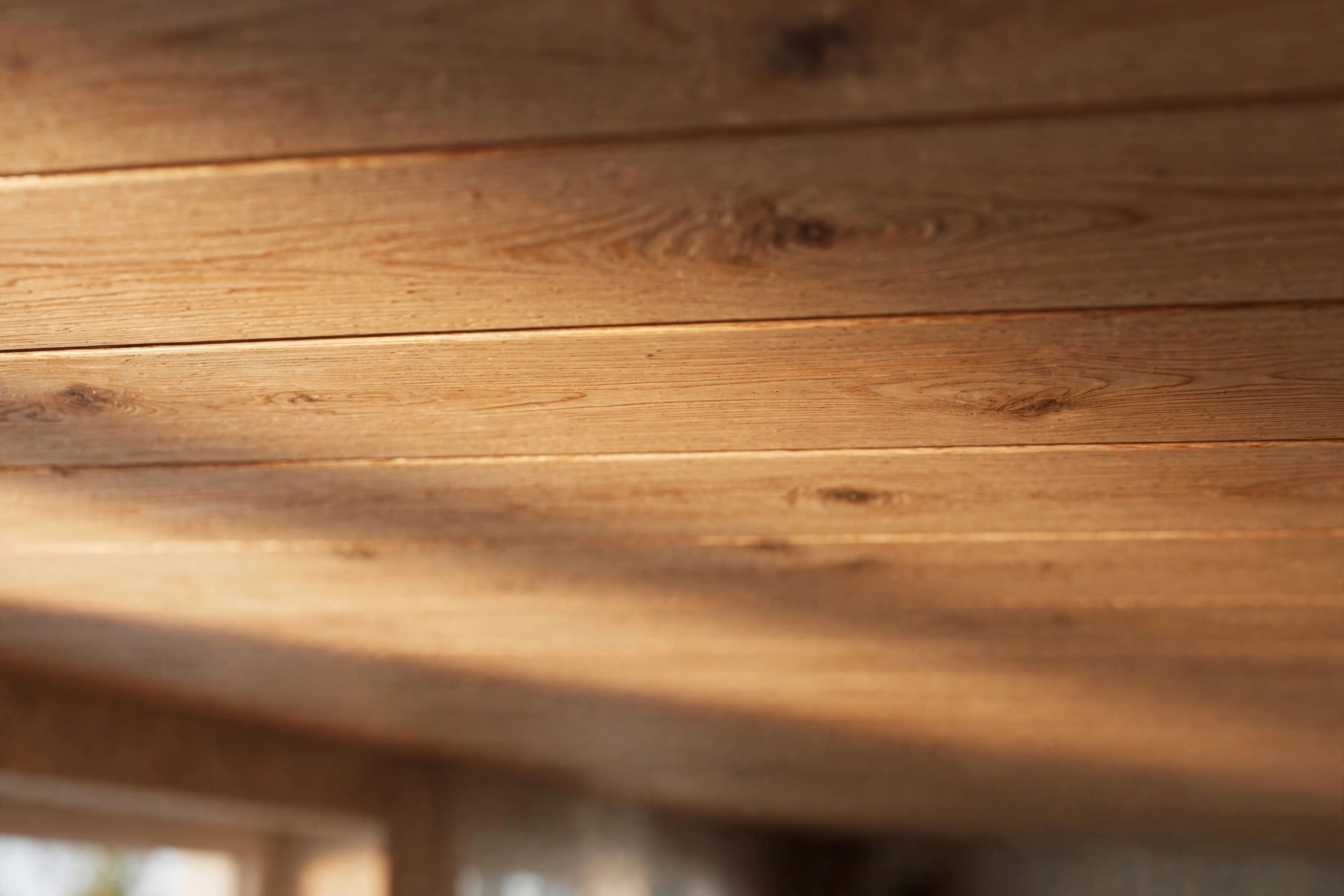 Close-up of wooden plank ceiling joints with a matte satin finish