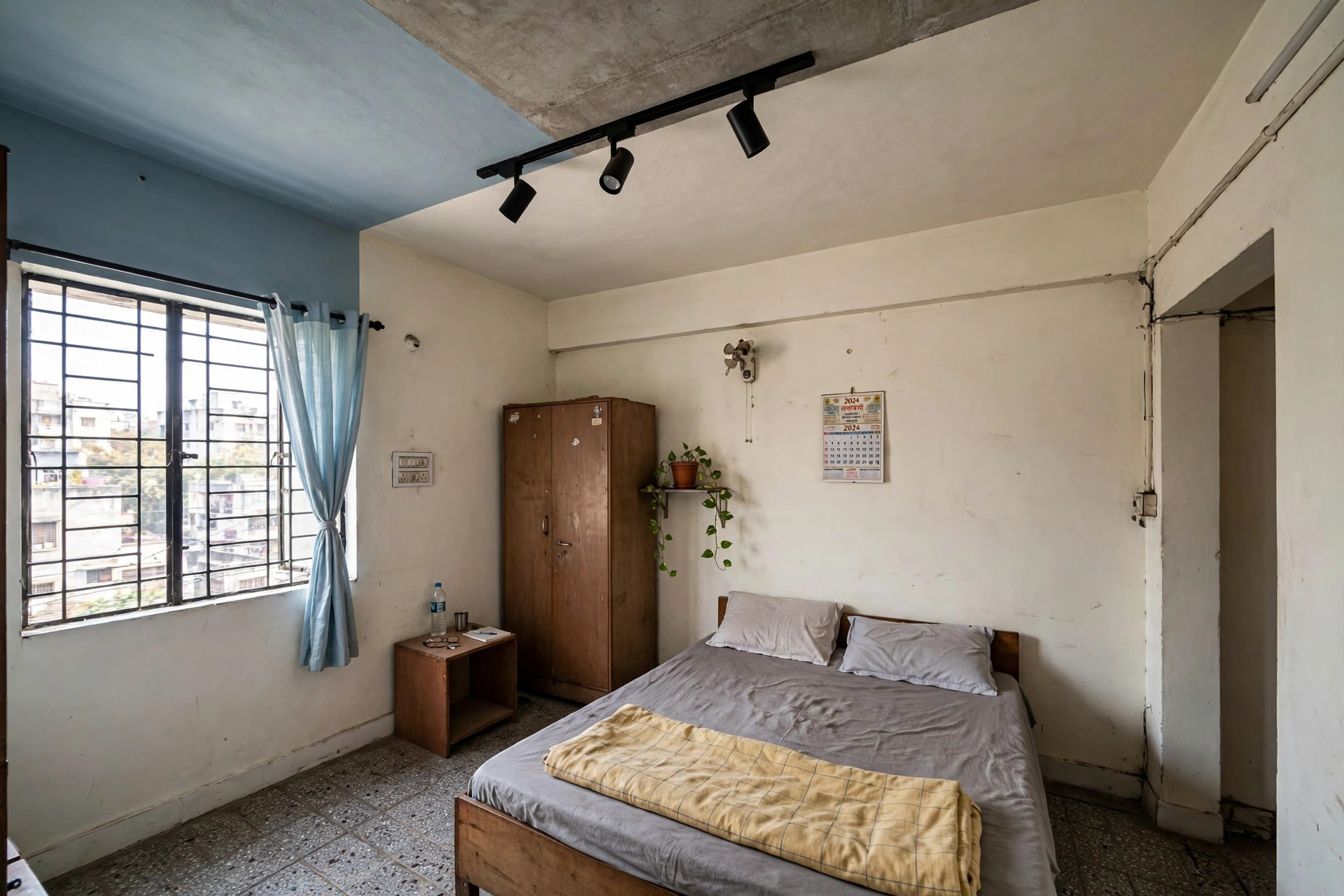 Bedroom with a paint-zoned ceiling and track lights, no false ceiling