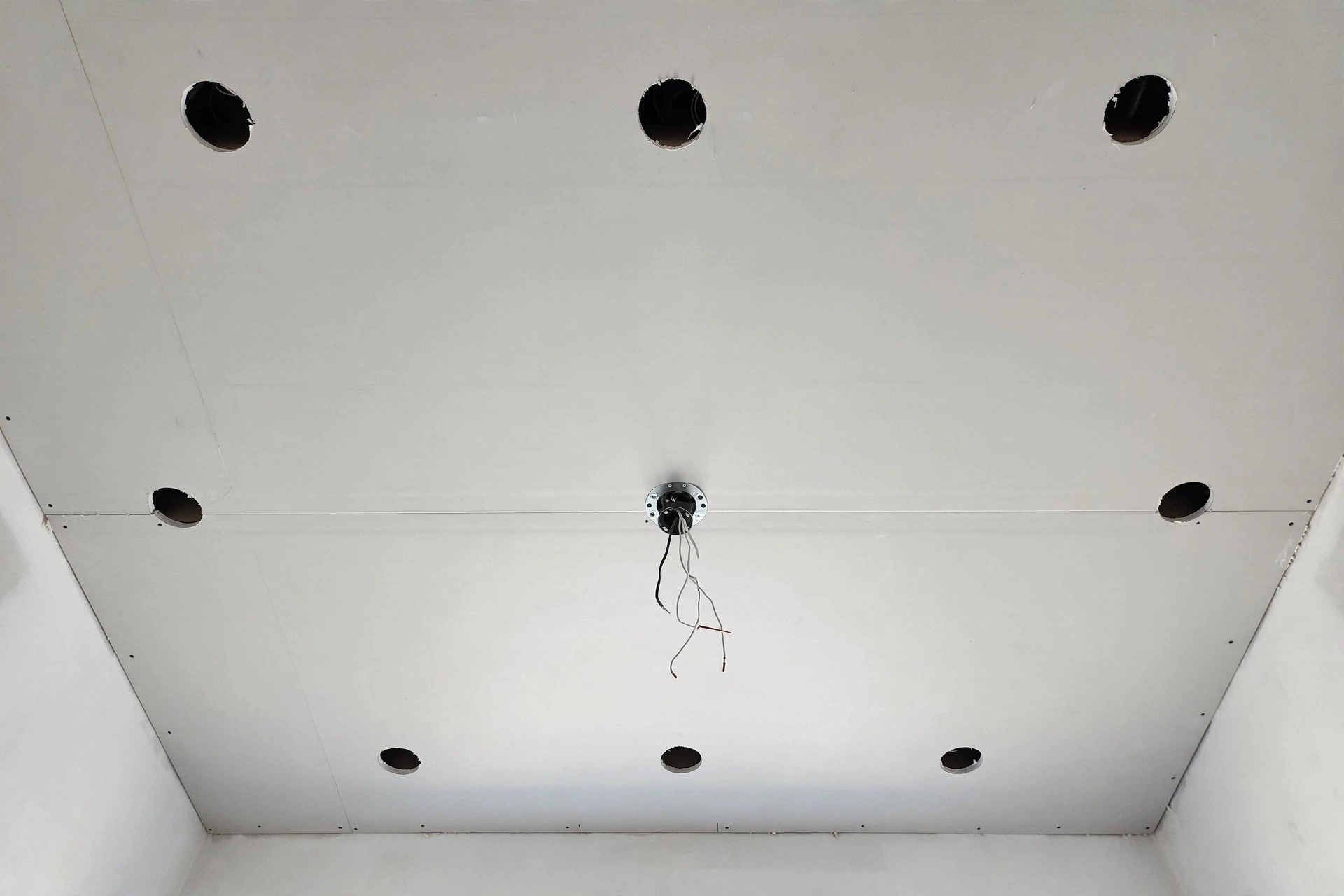 Concept render of a finished ceiling with light cutouts and a central fan mount