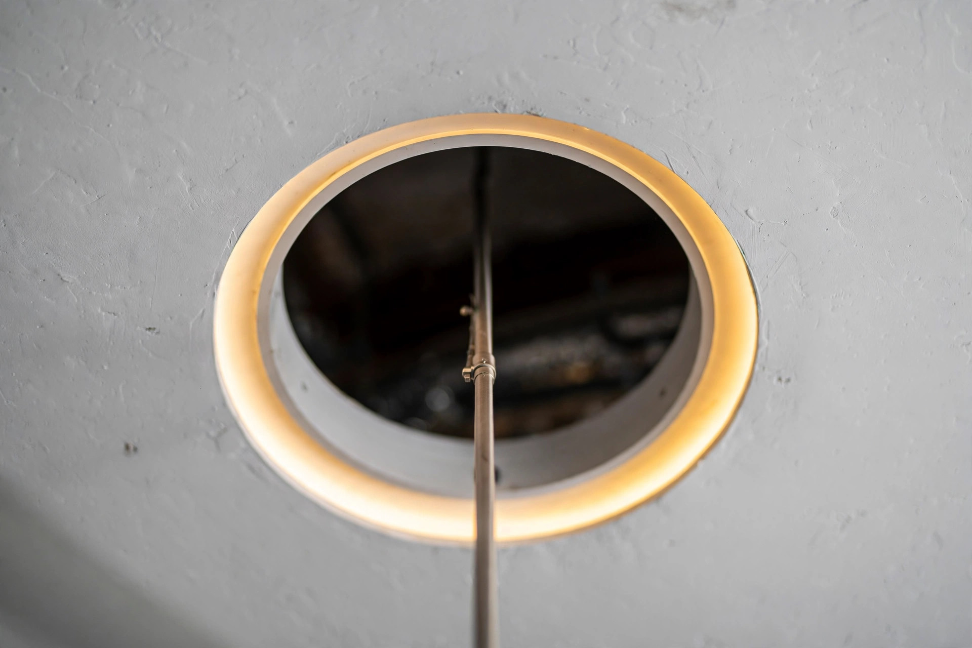 Close-up of a neatly framed circular fan cut-out with a cove light ring