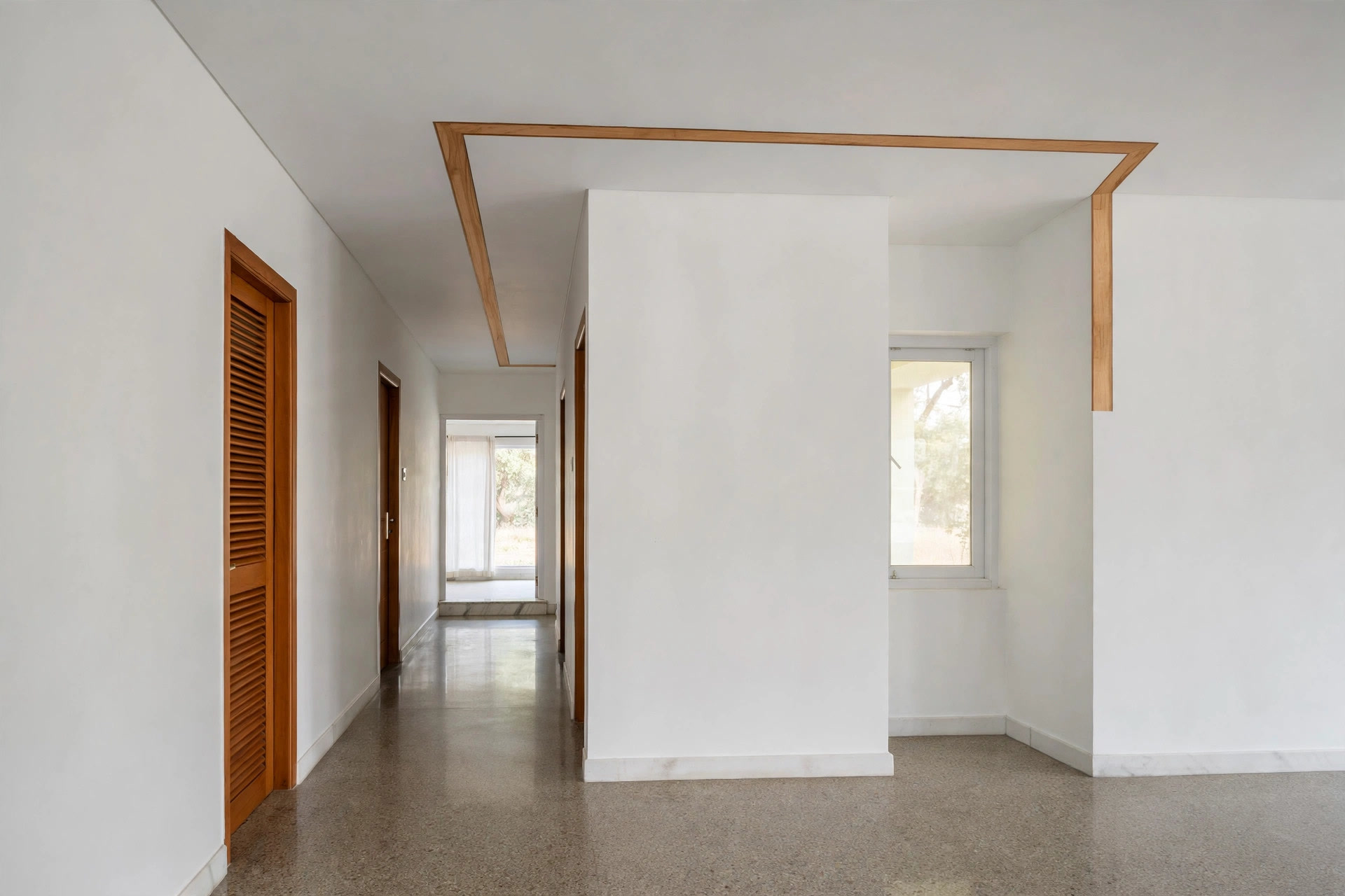 Wood veneer inlay strip following the L shape of a white hall ceiling