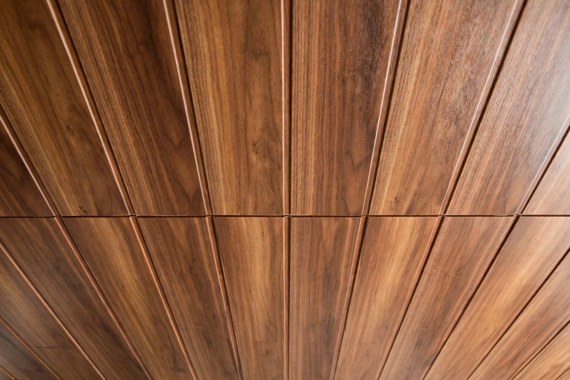 Close view of wood-grain laminated PVC panels on a hall ceiling