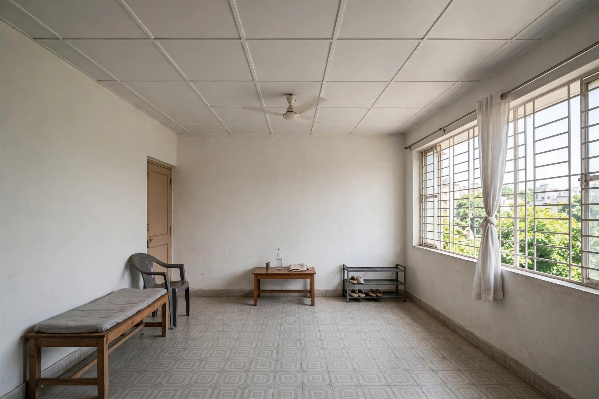 Rented apartment hall with a simple white PVC panel ceiling and minimal furniture
