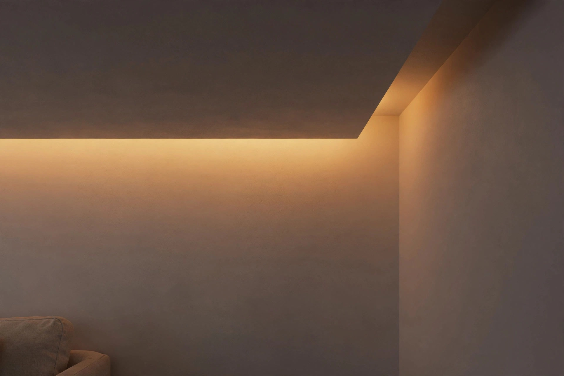 Close-up of warm indirect cove light washing a matte white ceiling corner in the evening