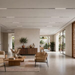 Modern Indian hall with a flat false ceiling and recessed lighting