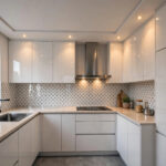 Compact Indian kitchen with a slim white gypsum false ceiling and recessed spotlights over the counter