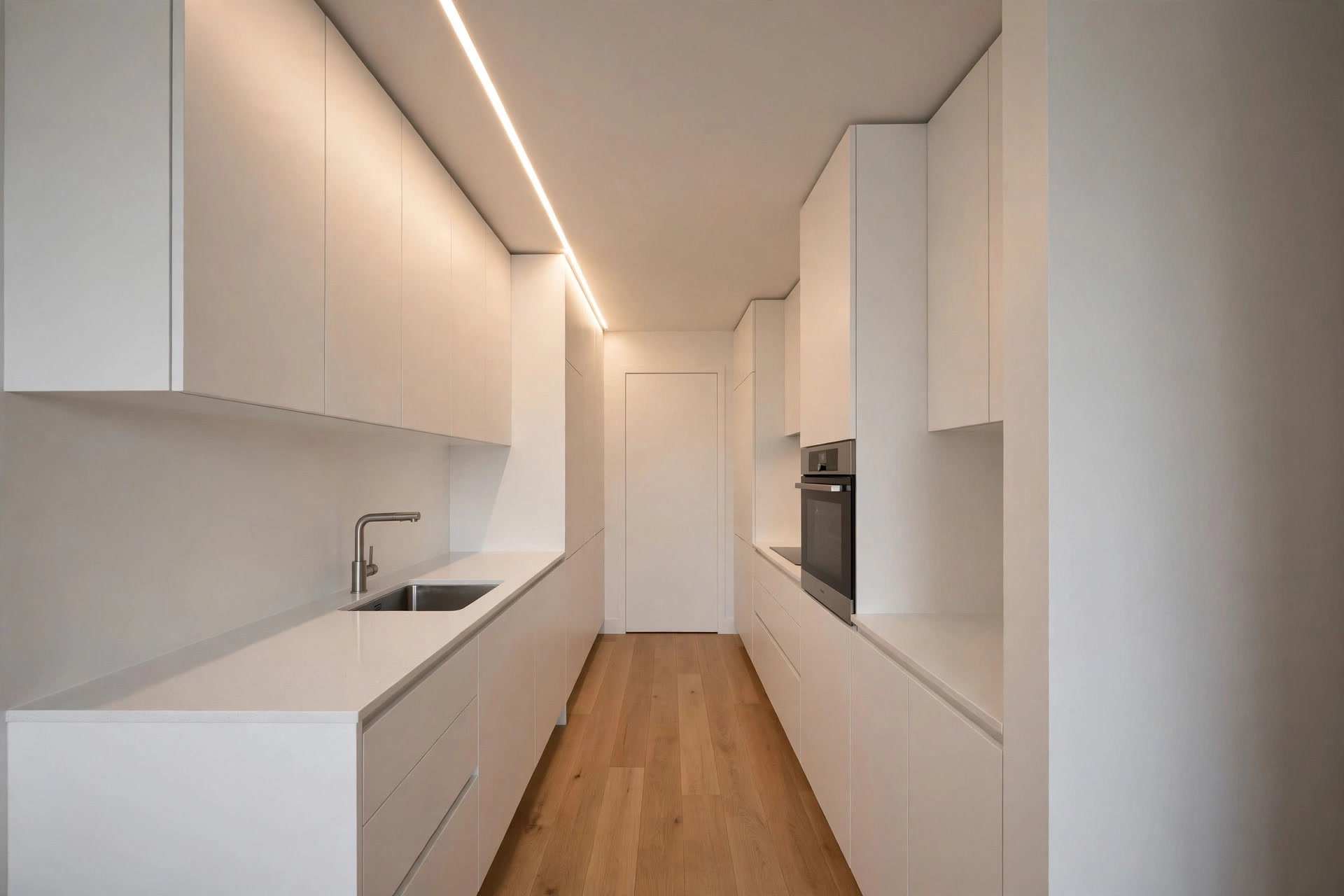 Narrow galley kitchen with a slim recessed ceiling strip running above the counter