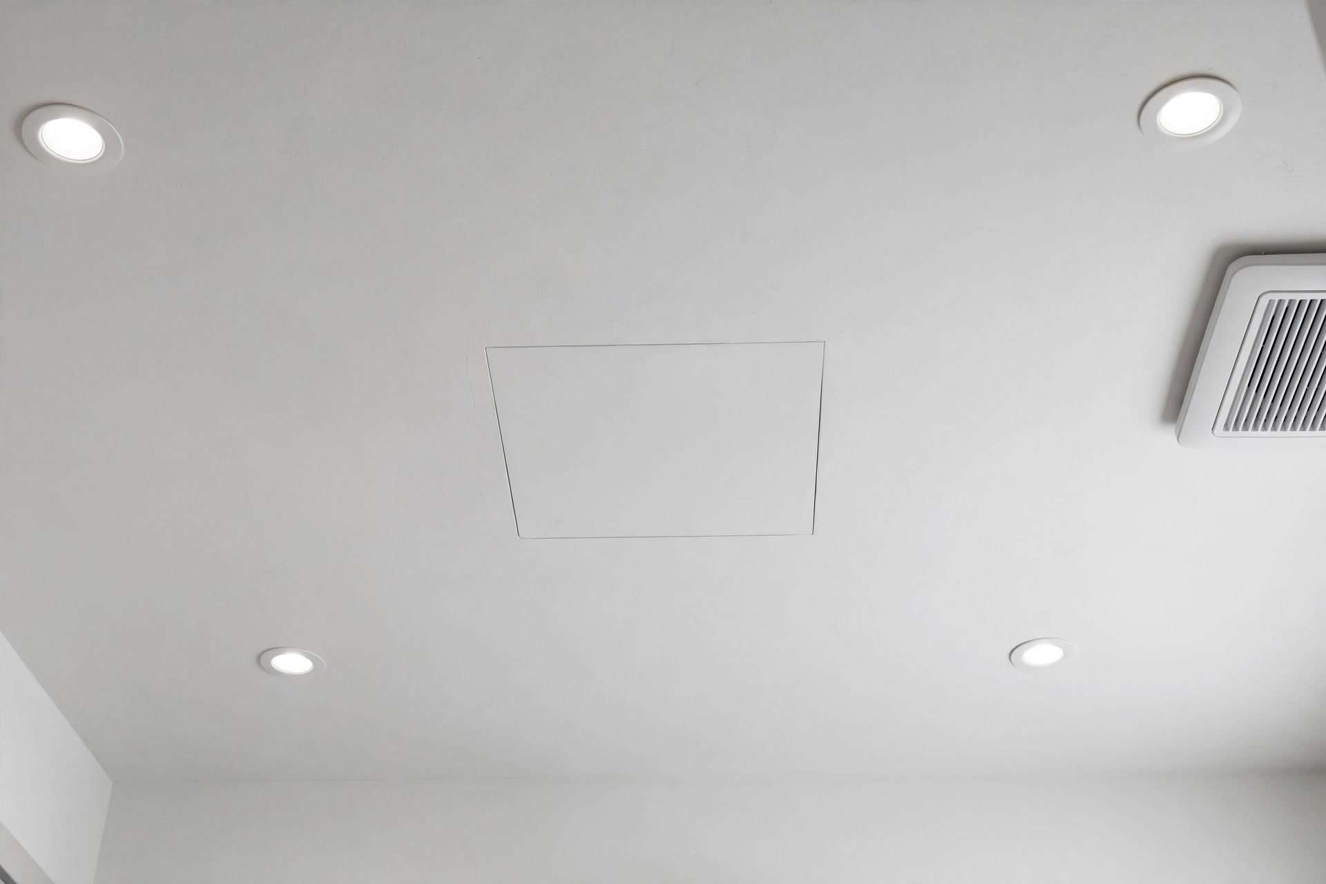 Bathroom ceiling with a discreet removable access panel matching the ceiling finish