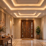 Elegant home lobby with a layered gypsum false ceiling, cove lighting and a wooden main door