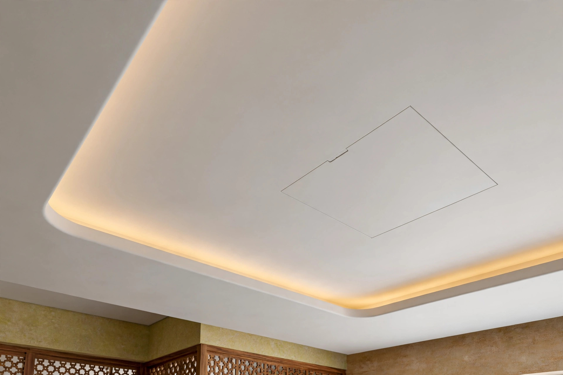 Discreet flush access panel in a white lobby false ceiling beside a cove light