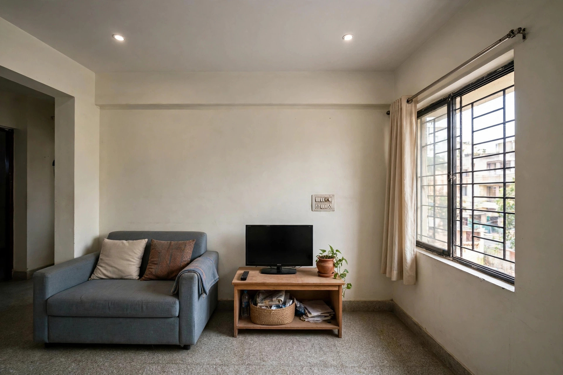Rental flat living room with a simple flat gypsum ceiling and two recessed spotlights