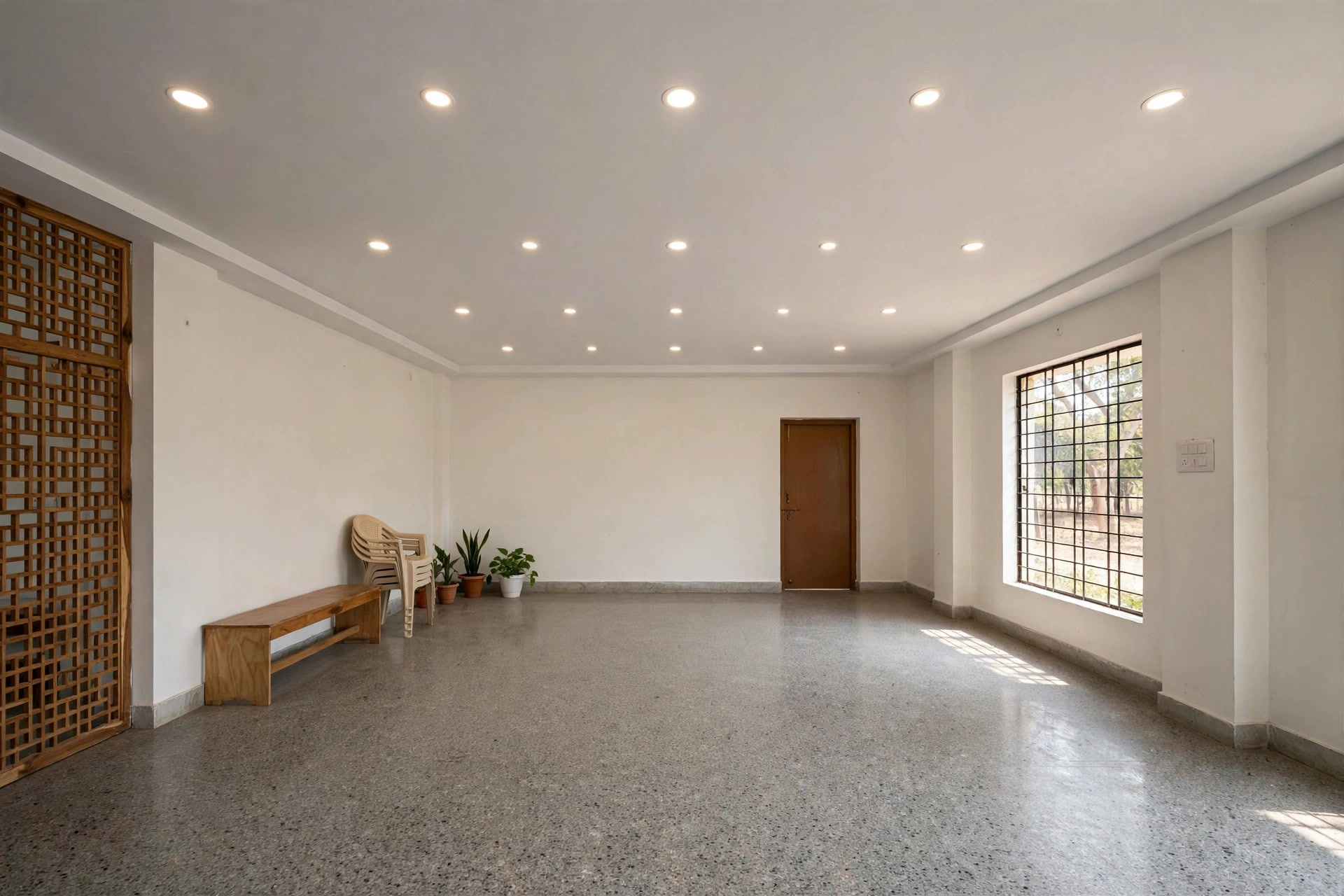 Hall with a simple flat white false ceiling and recessed lights