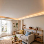Compact living room with a slim false ceiling and warm perimeter lighting
