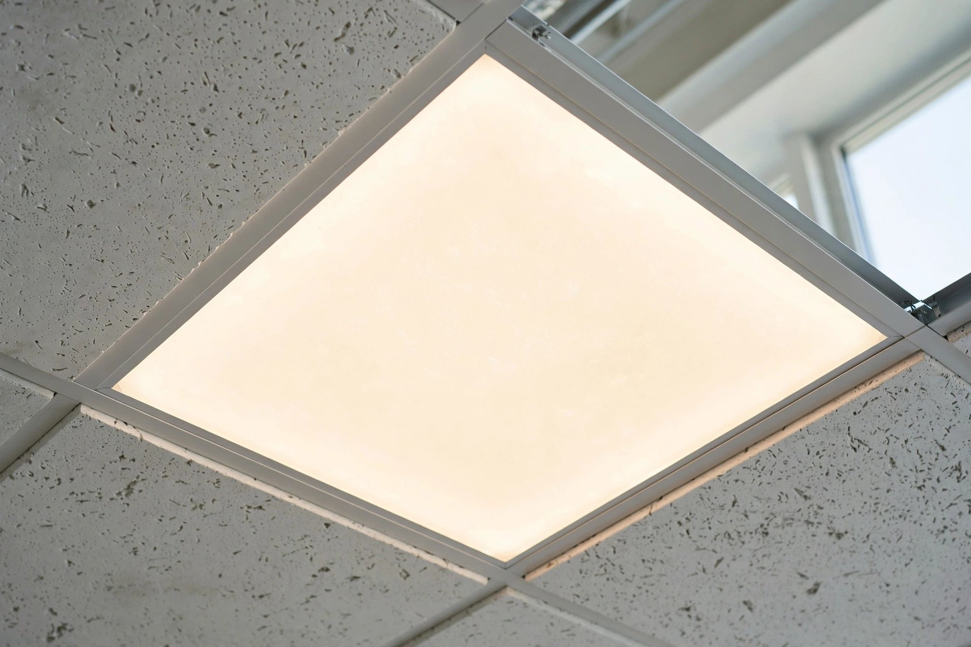 LED panel light fitted flush into a 600 by 600 grid module
