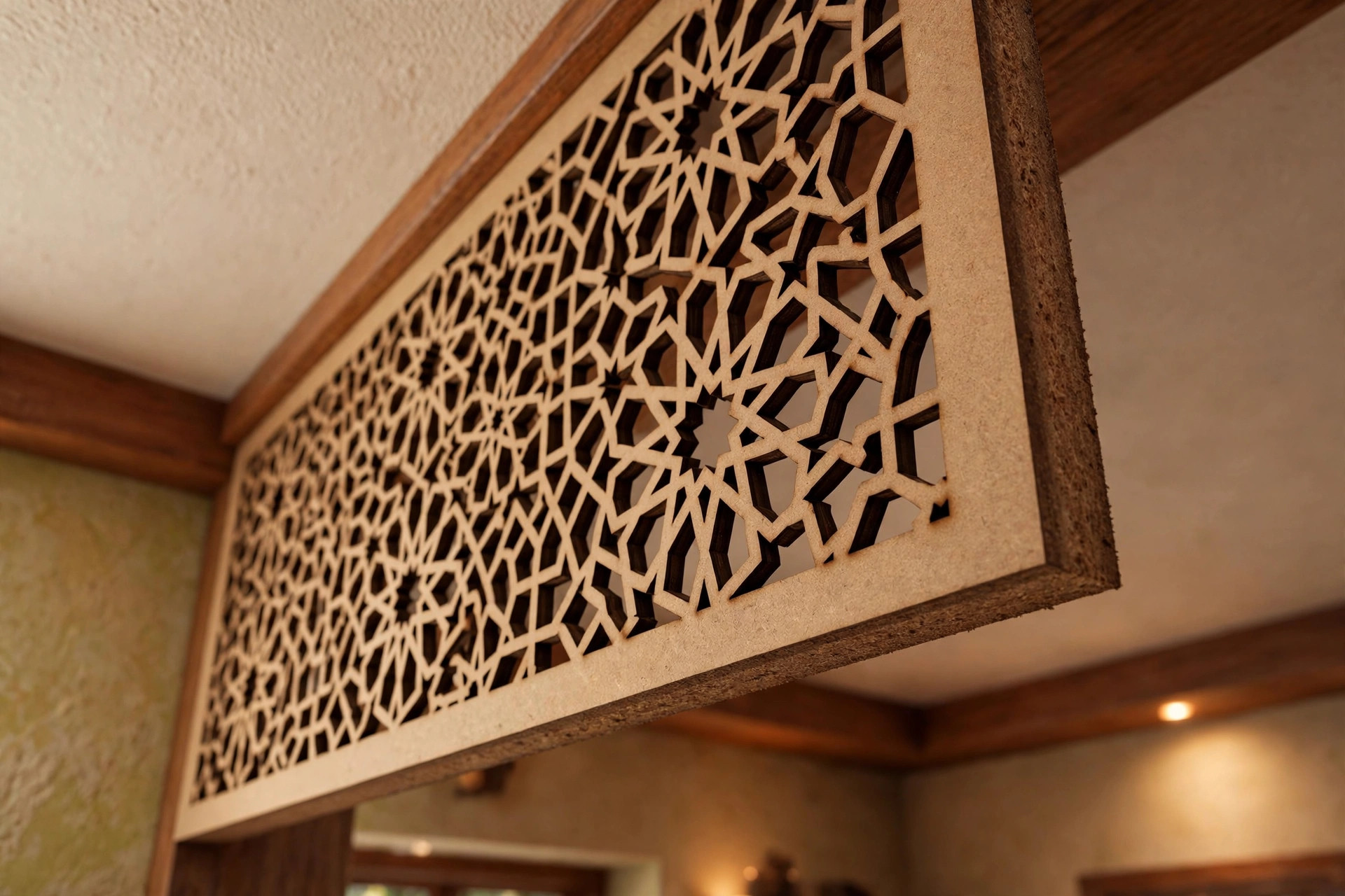 Close-up of a laser-cut MDF jali ceiling panel showing the cut pattern and panel thickness
