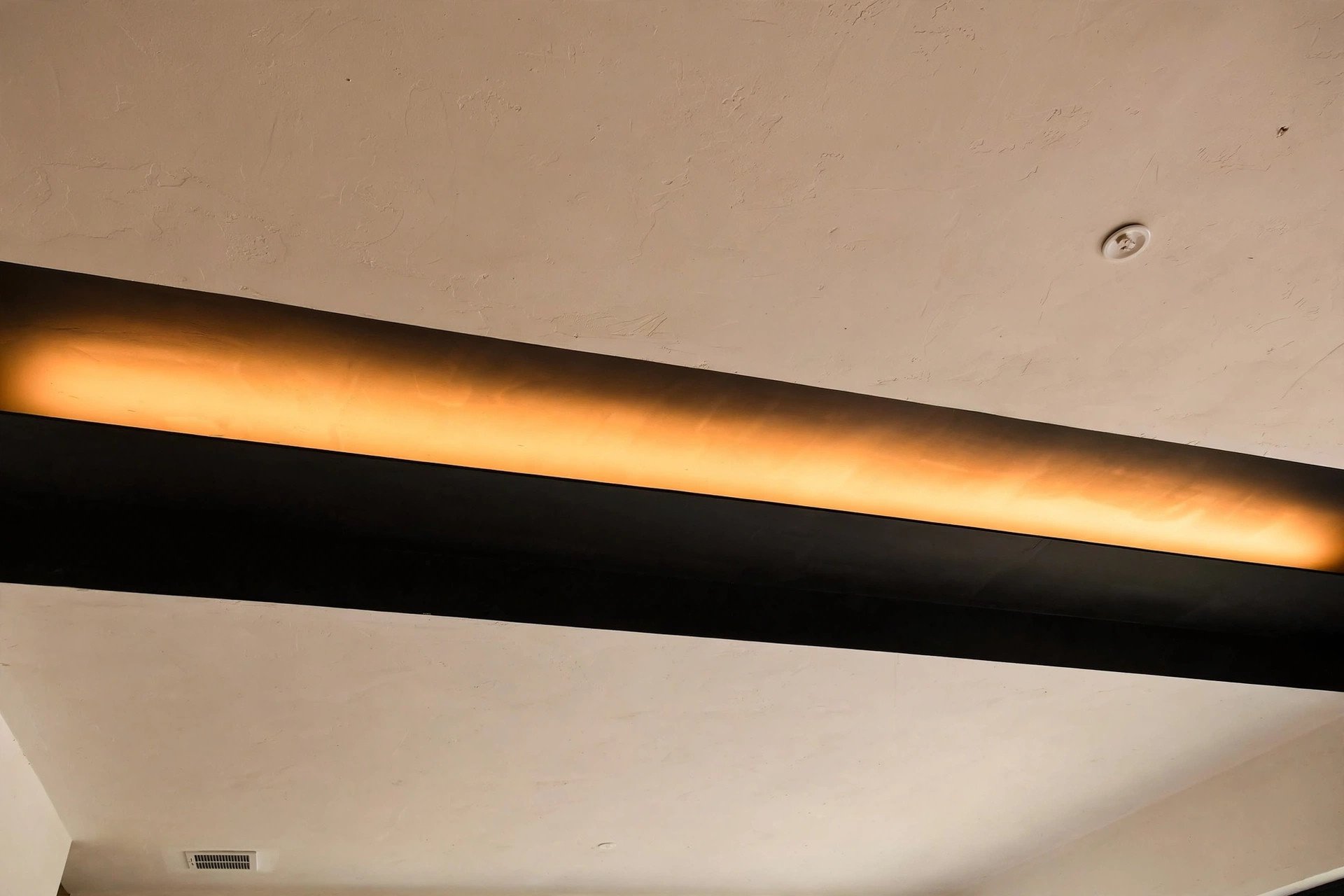 Concept render of a matte black accent band on a living room ceiling