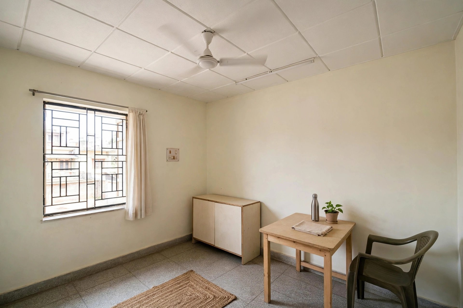 Simple plain white budget ceiling in a modest tidy Indian bedroom