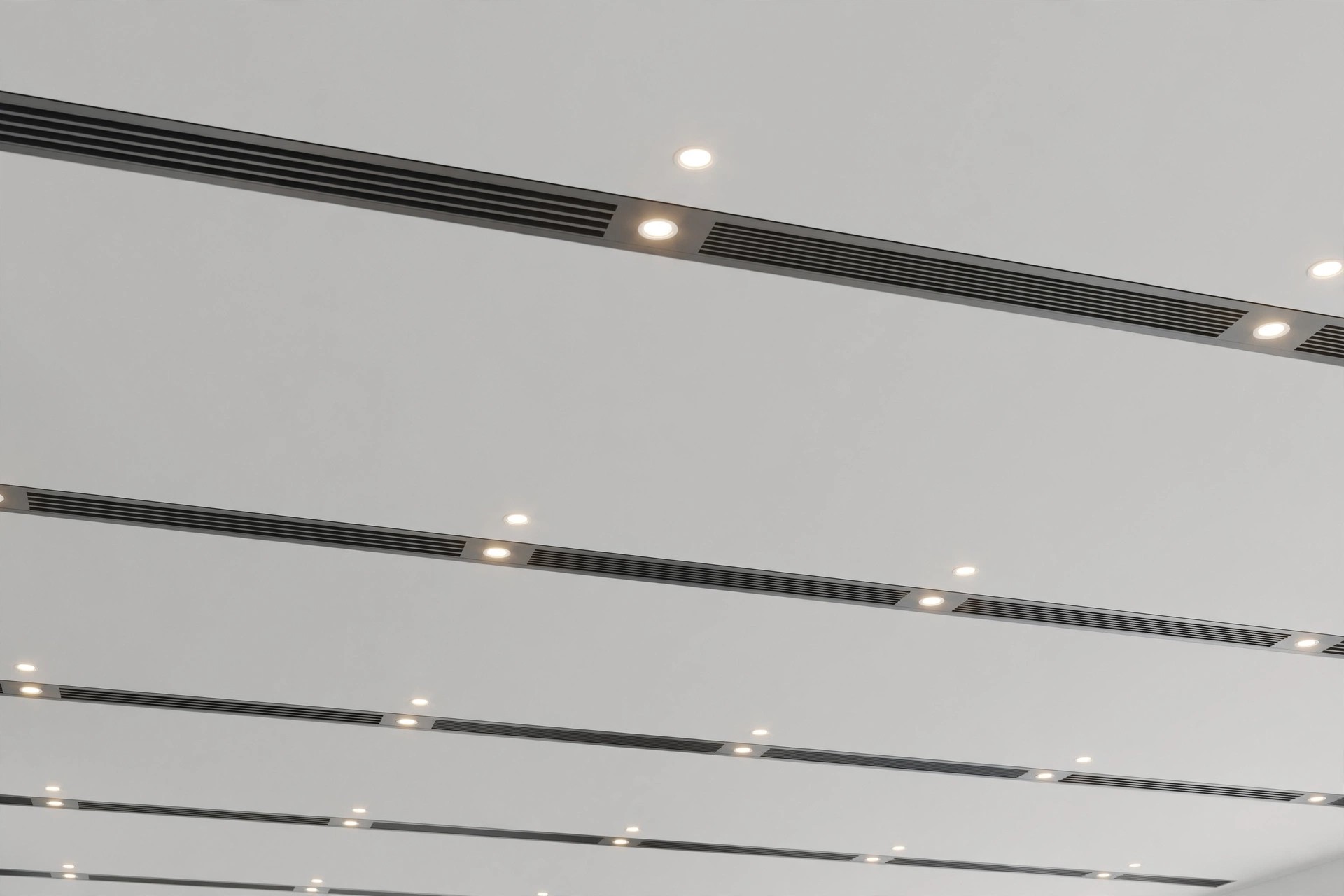 Office ceiling with linear AC slot diffusers neatly integrated into the ceiling plane